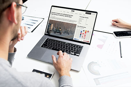 Person reviewing article on laptop